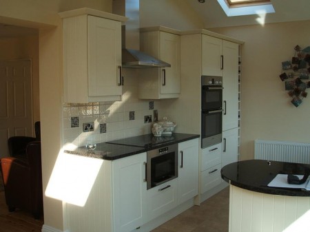 Granite counter tops complement the simple design of this ivory shaker kitchen installed in Kilkenny by Kitchen Makeover, Ireland