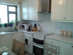 The pvc had peeled off some of the doors before the makeover of Mary's kitchen by  by Kitchen Makeover, Ireland