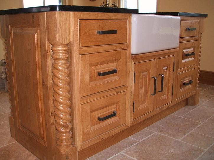 A close up of the oak island unit, incorporating belfast sink and granite counter manufactured and installed by Kitchen Makeover, Ireland.